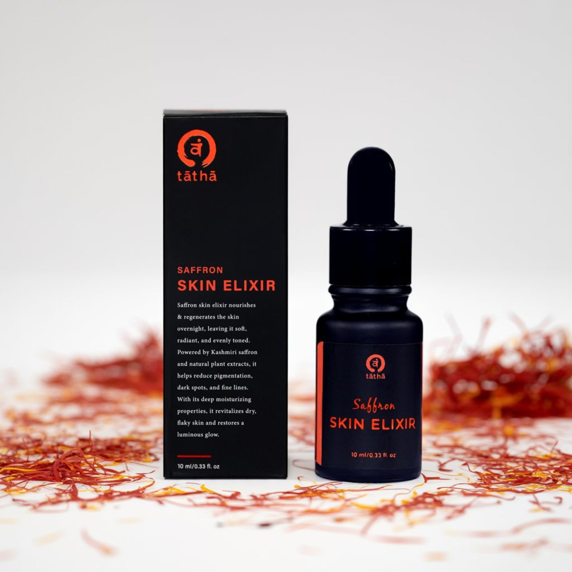 Tatha Saffron Skin Elixir displayed with open and closed box, featuring the 10ml dropper bottle.