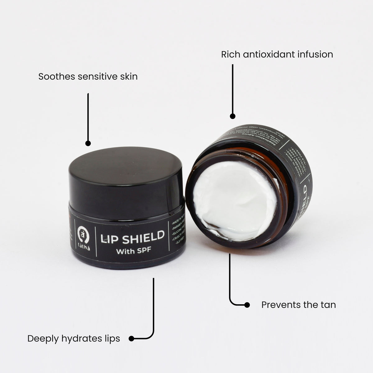 Tatha Lip Shield with SPF in a sleek black jar and cap, designed to soothe sensitive skin, infused with rich antioxidants, deeply hydrates lips and prevents tanning.