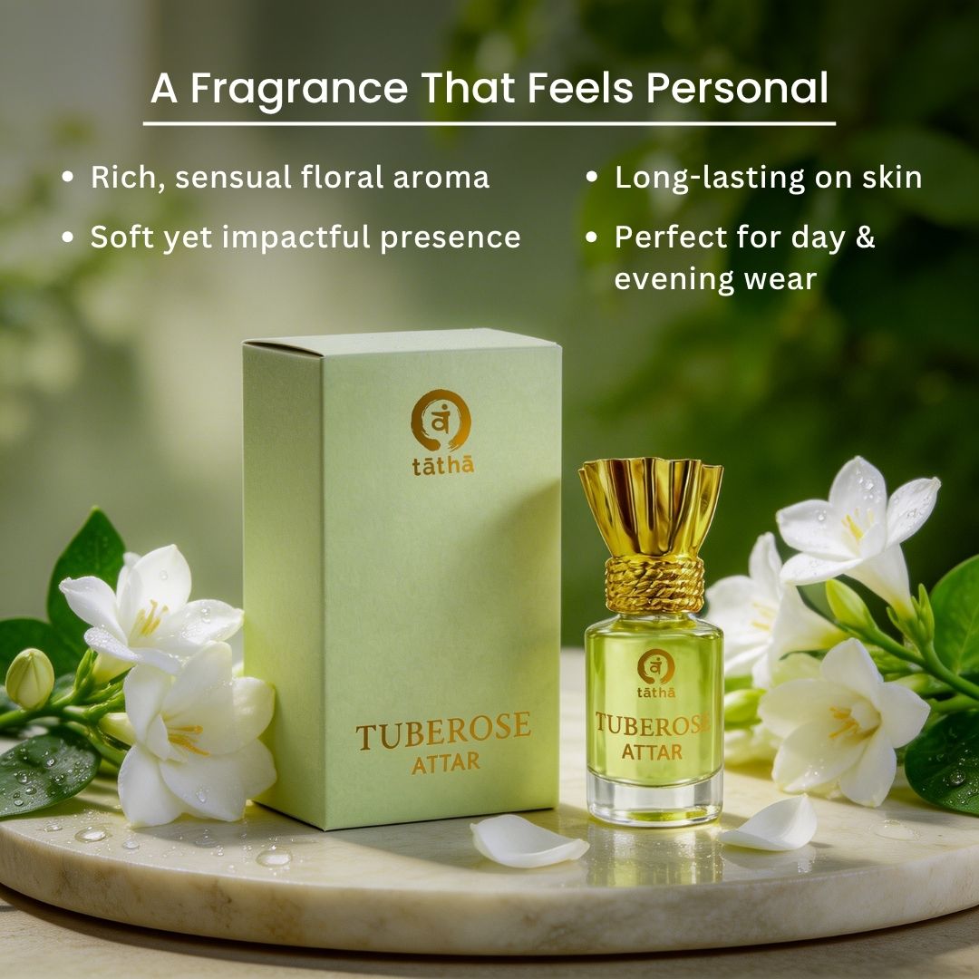 Tuberose attar with packaging on a marble surface with flowers