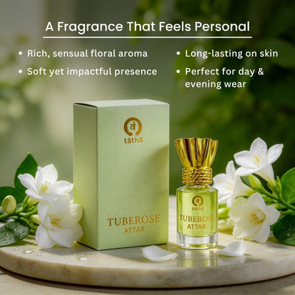 Tuberose attar with packaging on a marble surface with flowers