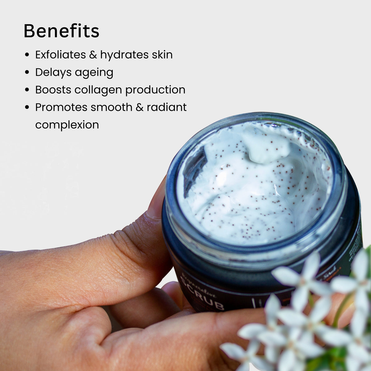 Tatha Regenerative Scrub in an open jar held in hand; exfoliates and hydrates skin, delays aging, boosts collagen production, and promotes a smooth, radiant complexion.